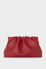 A red clutch bag made of grain Italian leather. The handbag has a removable strap and can also be worn as a crossbody bag.