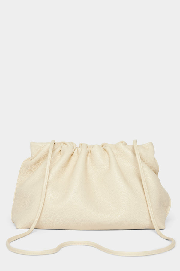 A white clutch bag with a long removable shoulder strap. The handbag can also be worn handheld or a crossbody bag. 