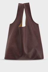 A large burgundy tote shoulder bag made of fine Italian grain leather. The bag is suited as a work bag or a travel bag.