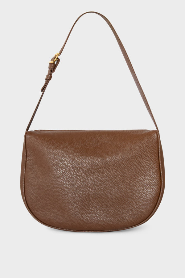 A medium-sized shoulder bag in brown made of fine grain Italian leather. It has a hobo inspired design with an adjustable shoulder strap.