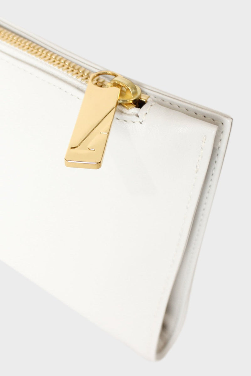 The slimline clutch pouch features a gold hardware and durable zipper and magnetic closures. This image features the clutch zipper with the initial A which stands for A-esque, the brand's name.