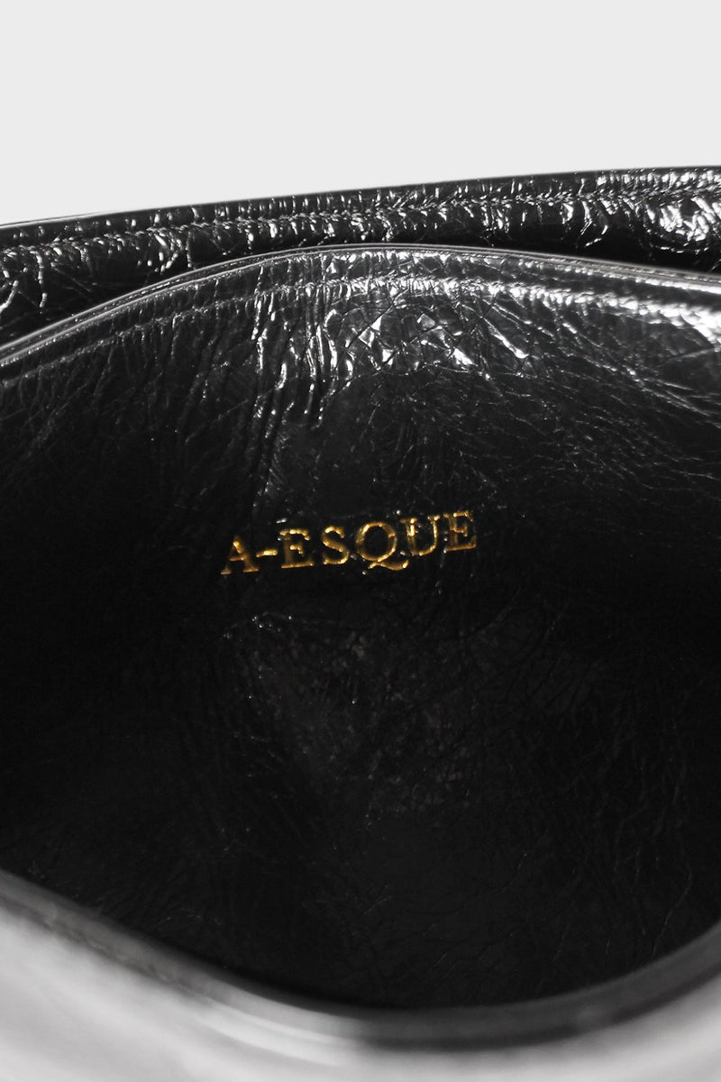 The interior of the slimline clutch with an A-esque logo pressed on the leather.