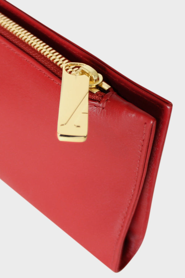 The slimline clutch pouch features a gold hardware and durable zipper and magnetic closures. This image features the clutch zipper with the initial A which stands for A-esque, the brand's name.