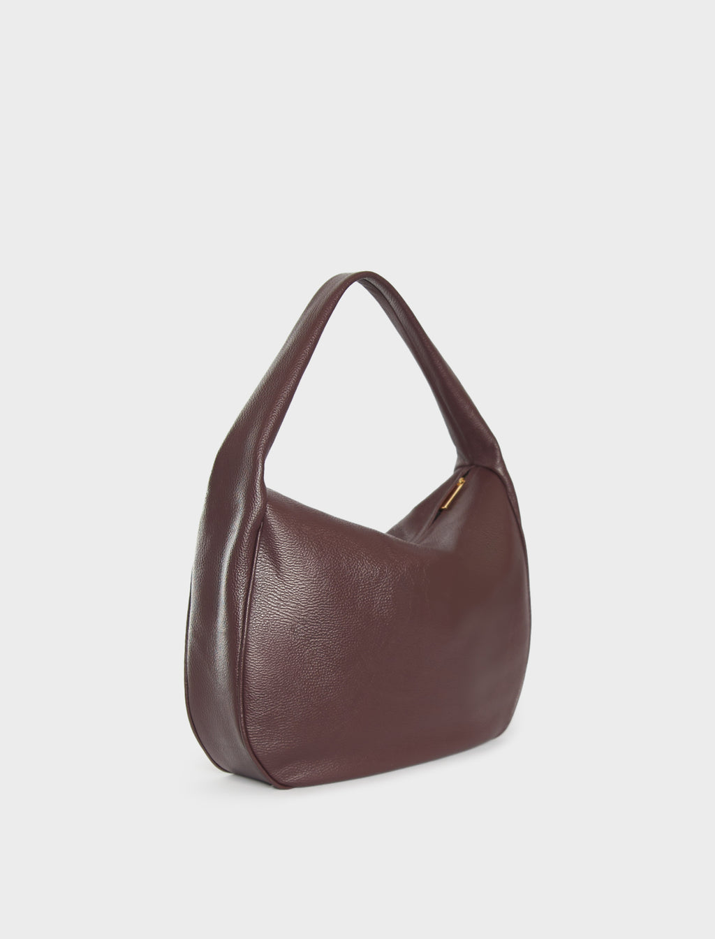 A side image of a shoulder bag in the color burgundy. The bag  follows a satchel like design with a large slim body. The bag is called Slimline Halo Shoulder Bag in Grain Burgundy.