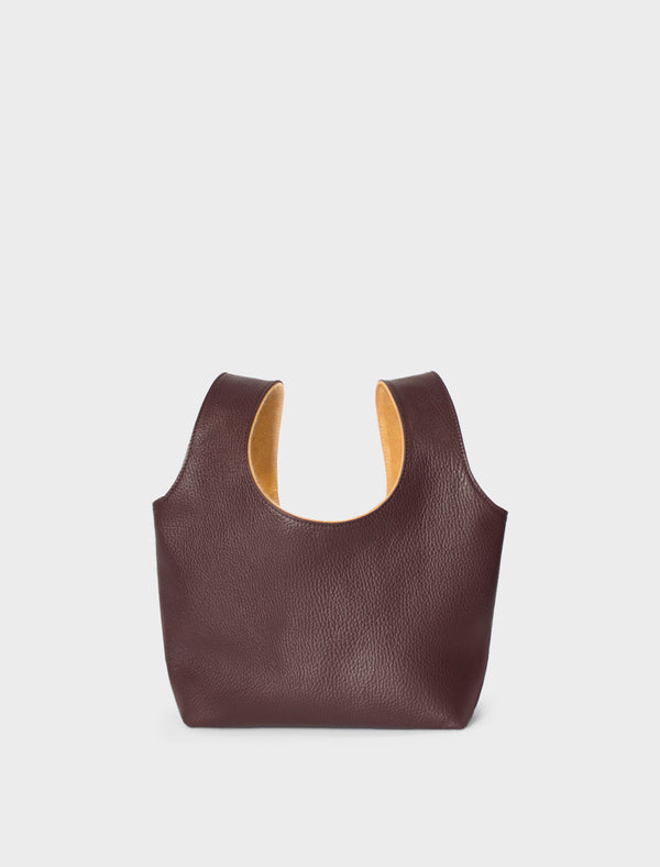 A burgundy mini bag. This handbag has a playful and casual design suited as a party purse or clutch. 