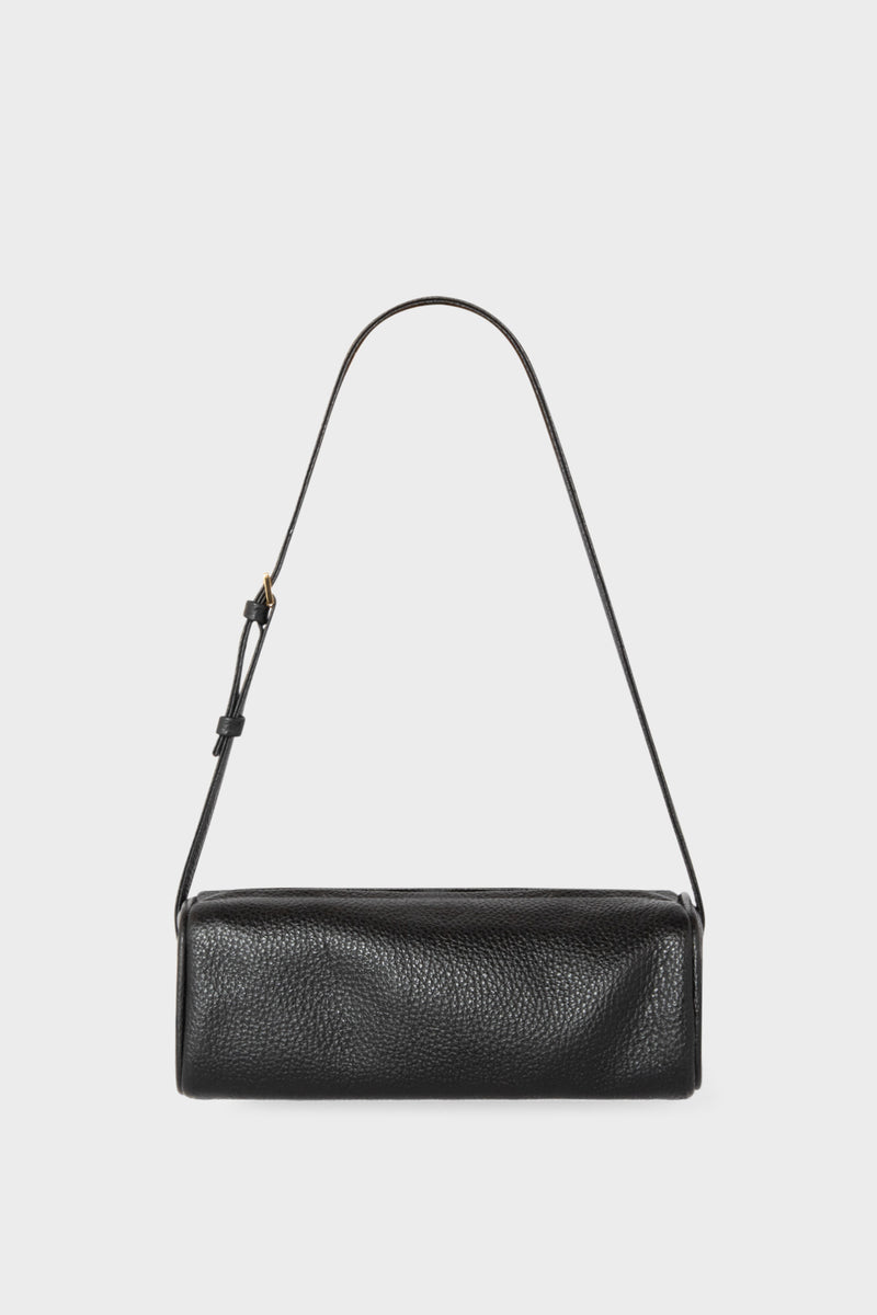 A small black shoulder bag made of grain Italian leather. The bag has a compact design and features an adjustable strap handle.