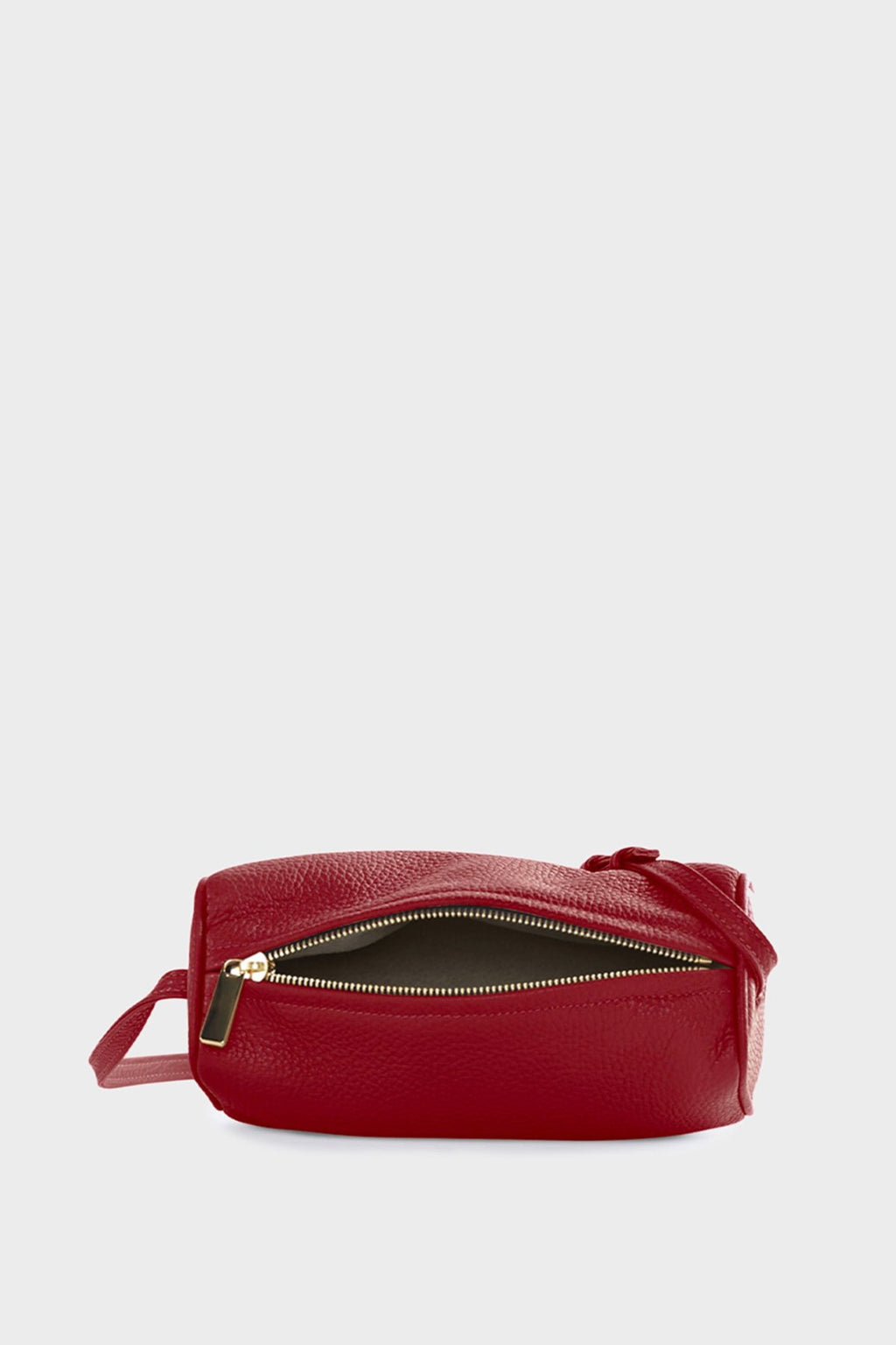 The small red barrel shoulder bag uses gold hardware and zipper with a white suede lining inside.