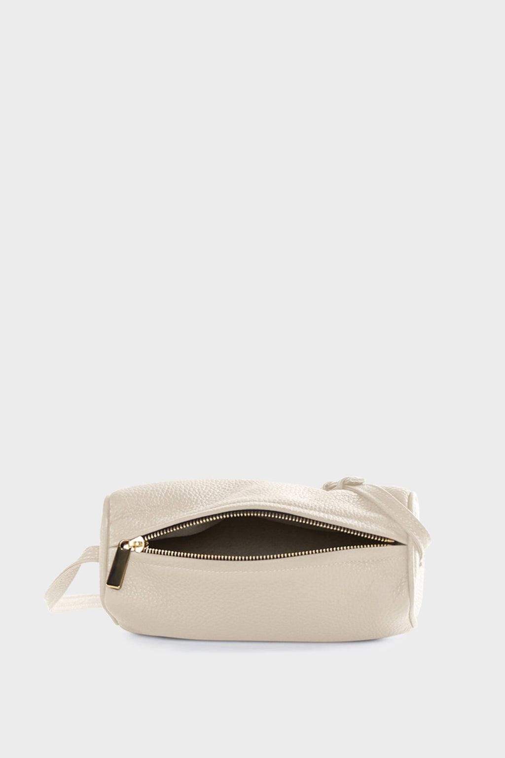 The small white barrel shoulder bag uses gold hardware and zipper with a white suede lining inside.