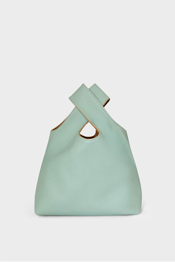 A small mint green handbag made of fine Italian grain leather. This mini bag is suited to carry as a clutch for casual events. 