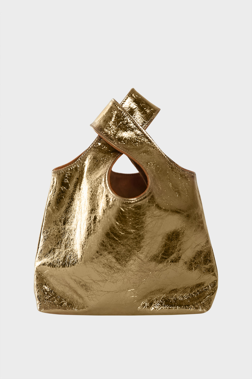 A small metallic gold handbag made of fine Italian leather. This mini bag is suited to carry as a clutch or purse for events.