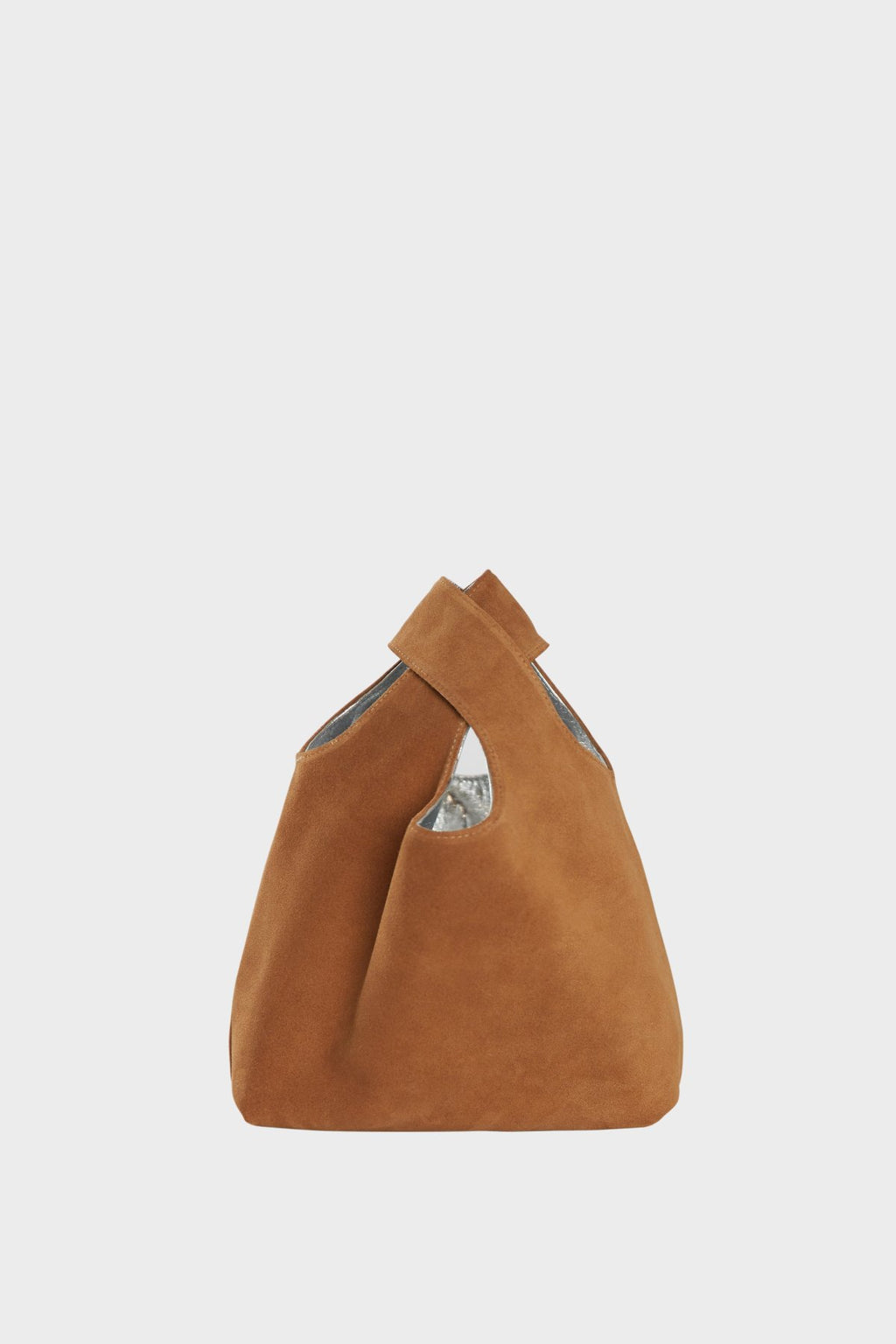 The suede side of the small reversible tote bag. The handbag is convertible to one side in metallic silver leather and the other in brown suede leather.