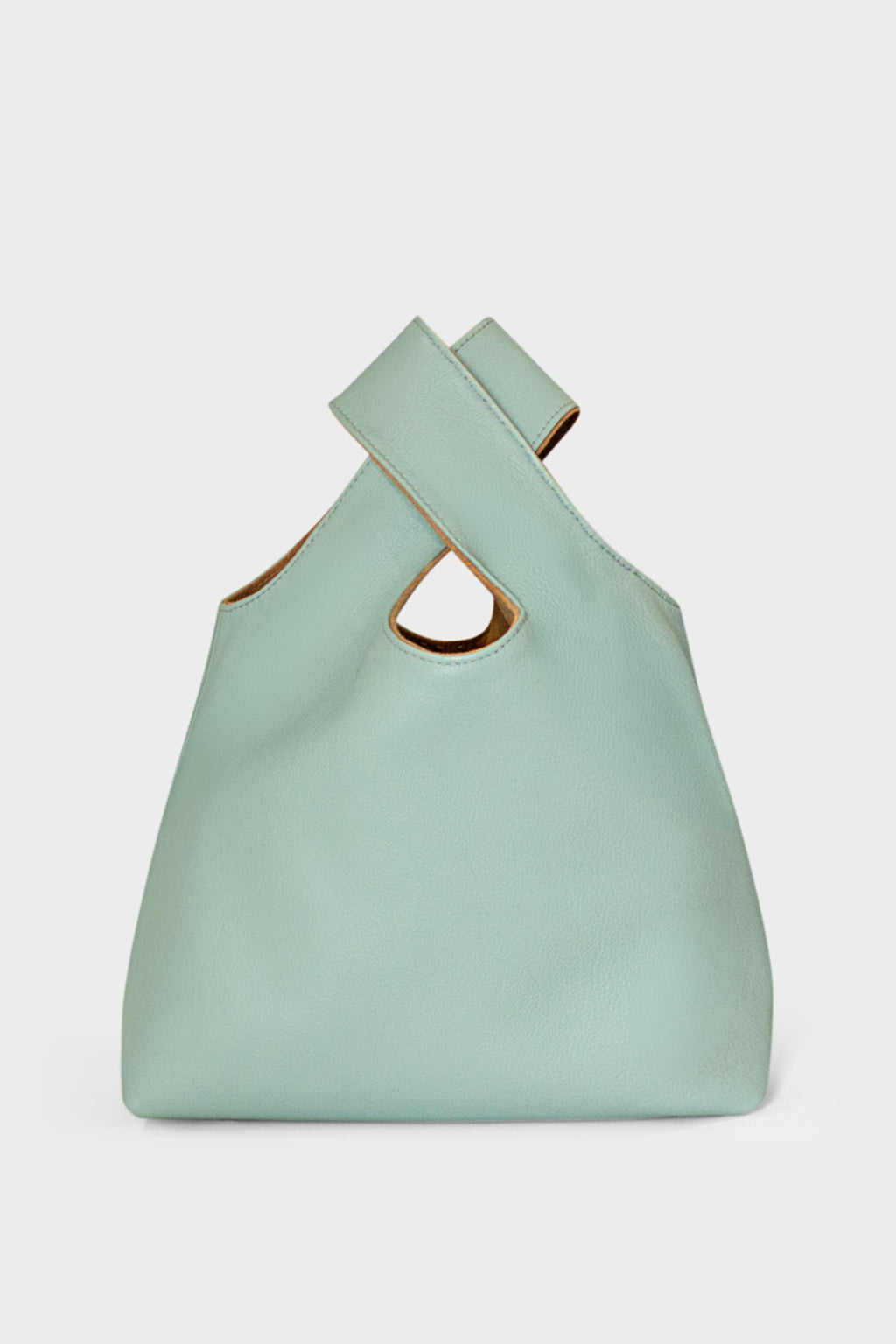 A small pastel green handbag made of fine Italian grain leather. This mini bag is suited to carry as a clutch for casual events.