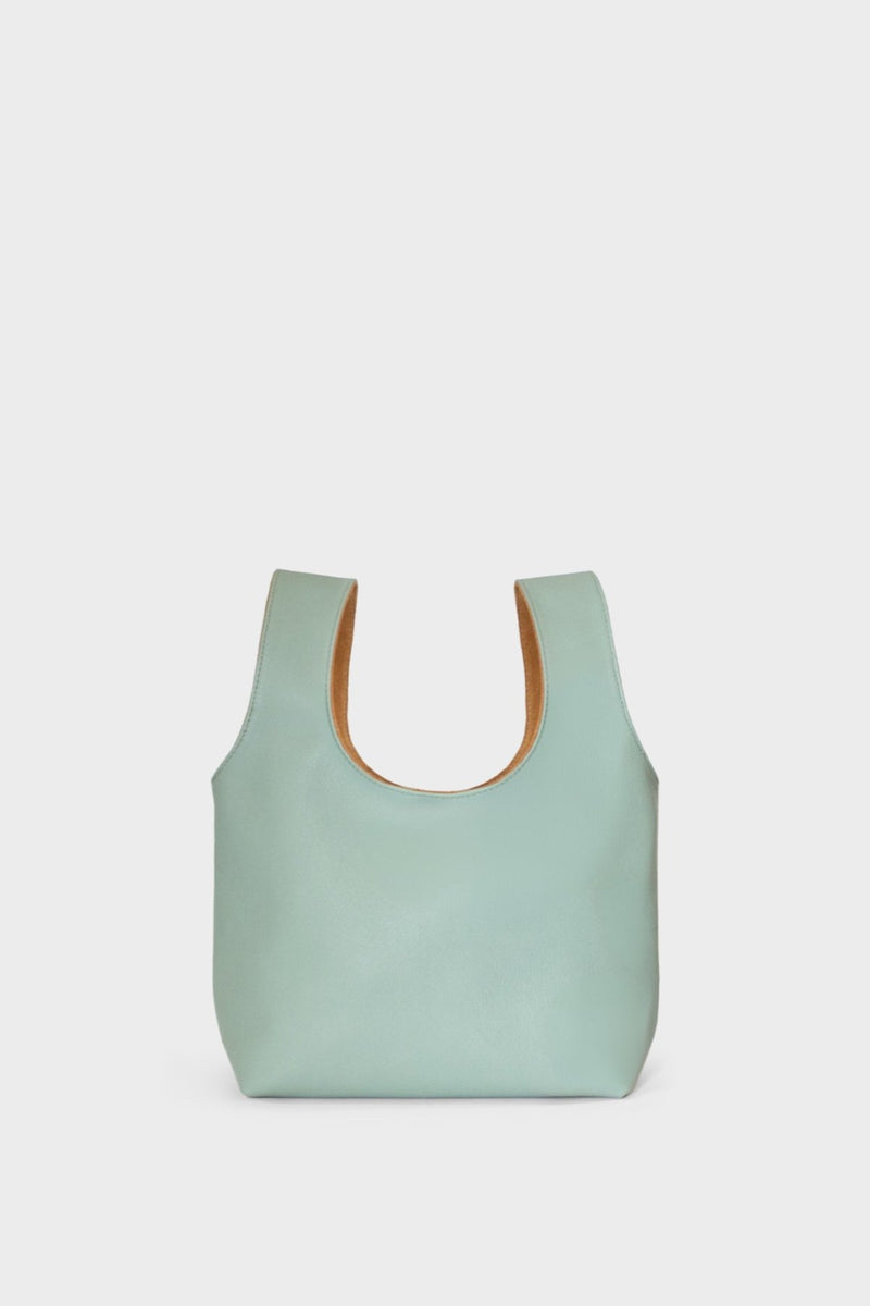 A pastel green mini bag. This handbag has a playful and casual design suited as a party purse or clutch.