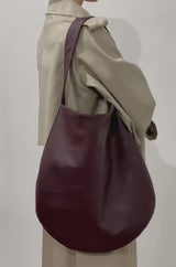 A wearing video of the One Hobo shoulder bag. It shows the front of the hobo showcasing its soft slouch in body.